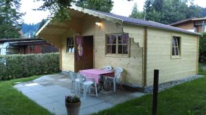 a small house with a pink table and chairs at SwissCottages Blockhaus in Schönengrund