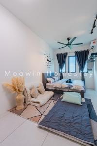 a living room with two beds and a couch at Comfy Studio Room by Moowin in Perai