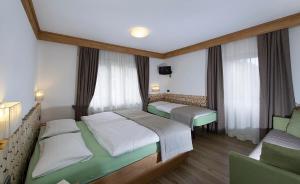 Postel nebo postele na pokoji v ubytování Hotel Aida
