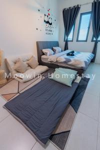 two beds sitting on the floor in a room at Comfy Studio Room by Moowin in Perai