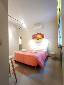 a bedroom with a bed with two towels on it at Baccaro's home B&B in Brindisi