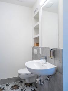 a bathroom with a sink and a toilet at Gästehaus Nikolai in Erfurt