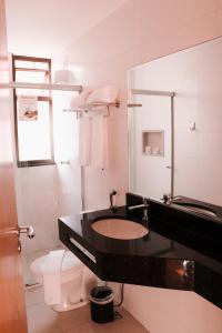 a bathroom with a sink and a toilet at Vida Plaza Hotel in Brasilia