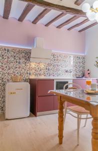 a kitchen with a white refrigerator and a table at Casa Rural La Molinera Etxea in Samaniego