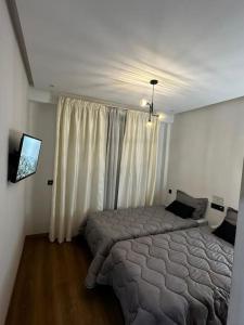 a bedroom with a bed and a large window at Appt Haut Standing - Agadir Bay in Agadir