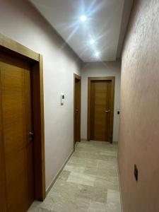 an empty hallway with two doors and a tile floor at Appt Haut Standing - Agadir Bay in Agadir