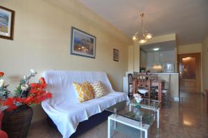 a living room with a white couch and a table at RNET-Nautilus Roses Costa Brava in Roses