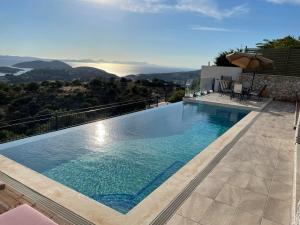 a swimming pool on the side of a house at Villa Buddha in Syvota