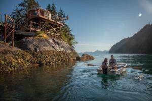 two people in a small boat in the water at Orca Island Cabins in Seward