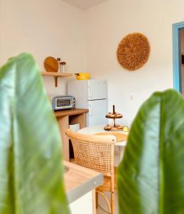 a kitchen with a table and two chairs and a table at Afroditi Junior Suites in Archangelos