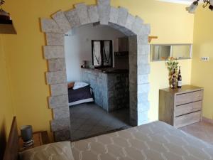 a room with a stone fireplace in a bedroom at Viktor rooms and apartments 2 in Rovinj