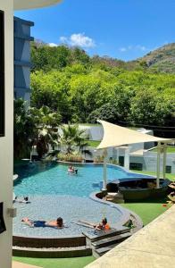 a group of people in a pool at a resort at Utopia - the best condo project at Naiharn in Rawai Beach