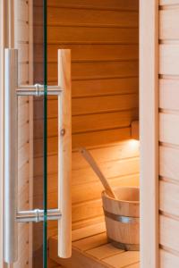 a wooden sauna with a wooden bucket at Le Torri - Castiglione Falletto in Castiglione Falletto