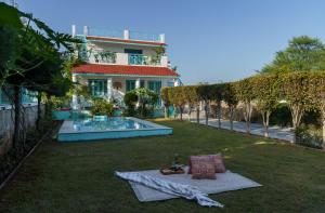 a blanket on the grass in front of a house at Thaharo 2 BHK Luxurious Villa in Udaipur in Thūr