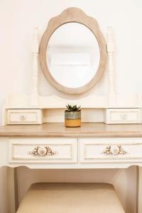 a white dresser with a mirror on top at Quercus Villa, Achilleion Palace, Corfu in Perama