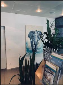 a room with a painting of an elephant on the wall at Work Life Residence by Frauenfeld in Frauenfeld
