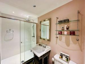 a bathroom with a sink and a shower and a toilet at Priory Manor Luxury on Lake Windermere in Windermere