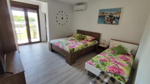 a room with two beds in a room with a window at Viktor rooms and apartments 2 in Rovinj +79 photos
