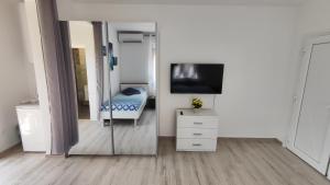a mirror in a room with a bed and a television at Viktor rooms and apartments 2 in Rovinj