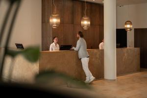 two women standing at a counter in an office at Seehotel am Kaiserstrand in Lochau