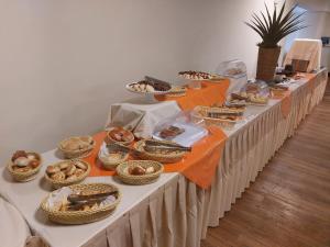 a long table filled with different types of food at Hotel Financial in Belo Horizonte