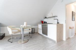 a small kitchen with a table and a counter at Haus Wolkentraum - Fewo Wolken mit Balkon und Bio-Kamin in Zinnowitz
