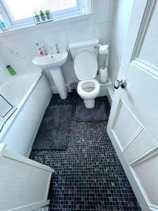 a small bathroom with a toilet and a sink at Merseybeat Short stays in Birkenhead