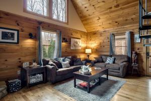 a living room with a couch and a table at Cozy Cabin Retreat: Tiny Trotter in Bryson City +30 photos