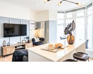 a living room with a table with a plate of food at Newport's heart: Steps from shops & local charm! in Newport