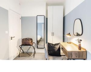 a room with a desk and a chair and a mirror at Newport's heart: Steps from shops & local charm! in Newport
