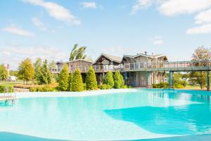 a large swimming pool in front of a house at Power Park Accommodation in Härmä