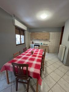 a dining room with a table and a kitchen at Villesse Appartamenti 