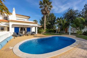 a swimming pool in front of a house at Casa Neel in Boliqueime