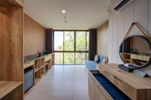 a bathroom with a mirror and a large window at Anagata 2 Tanjung Benoa Bali in Nusa Dua