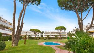 a courtyard with a swimming pool and trees at CP 13-A - Calella de Palafrugell in Calella de Palafrugell