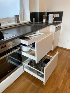 a kitchen with white cabinets and a black counter top at Appartement Emat 13 in Telfs