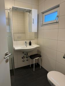 a bathroom with a sink and a toilet at Appartement Emat 13 in Telfs