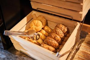 a wooden box filled with lots of different types of bread at Jalta Boutique Hotel in Prague