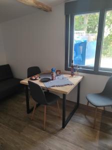 a table in a room with chairs and a window at Klid in Budyně nad Ohří