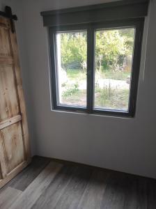 an empty room with a window and a wooden floor at Klid in Budyně nad Ohří