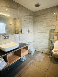 La salle de bains est pourvue d'un lavabo et de toilettes. dans l'établissement De Elaaf The Luxury Stay, à Srinagar