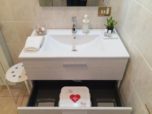 a bathroom with a sink with a heart box under it at Sunrise in Monterotondo