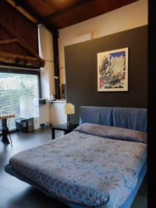 a bedroom with a bed with a blue bedspread at Anna e Gaetano in Misterbianco