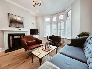 a living room with a couch and a table at The Pontcanna Sapphire 2-Bed Haven in Cardiff