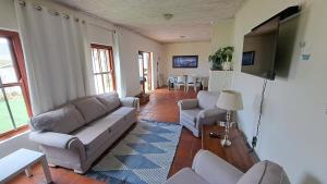 a living room with a couch and a flat screen tv at Ons Fontein in Langebaan