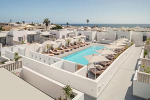 an aerial view of a resort with a pool and umbrellas at Nazaret Beach - Adults only in Arrecife