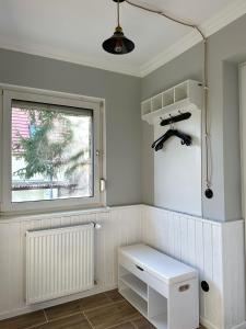 a white room with a window and a bench at Rustic Charm - Cottage by Comfort Housing in Kolonie Neudöberitz