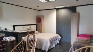Un dormitorio con una cama y dos sillas. en Los Manzanares, monoambiente, en Veintiocho de Noviembre