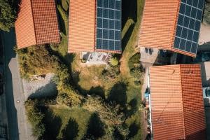 an overhead view of two orange buildings with solar panels at Stilvolles Chalet mit hauseigener Sauna & Whirlwanne in Viechtach +4 photos