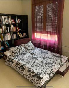 a bedroom with a bed and a book shelf at Apartamento con gran terraza y vistas a la catedral. in Burgos